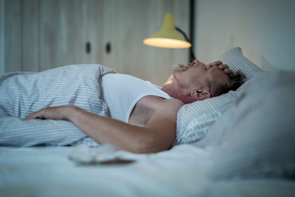 elderly man suffering from sleep apnea