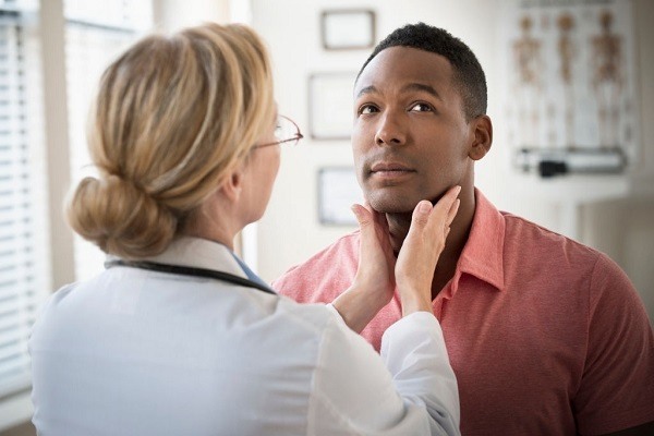 ENT doctor examining throat of a patient suffering from sleep apnea