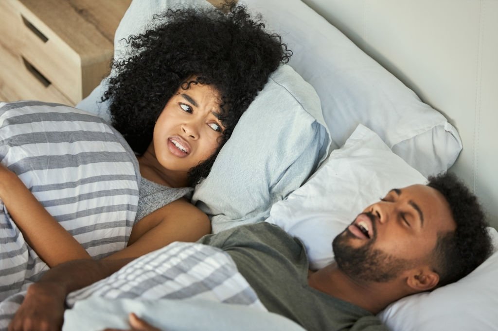 woman getting irritated with her husband on excessive snoring sleep apnea