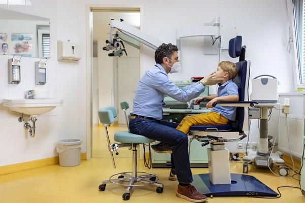 pediatric ent doctor checking up a boy nose